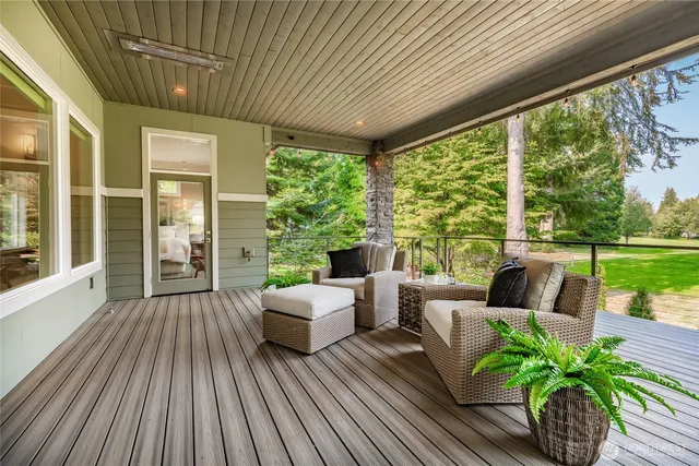 a living room with patio furniture and garden