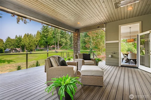a balcony with furniture and wooden floor