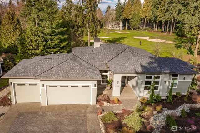 a aerial view of a house with a yard table and chairs