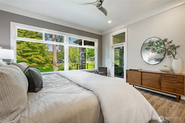 a bedroom with a large bed and a large window