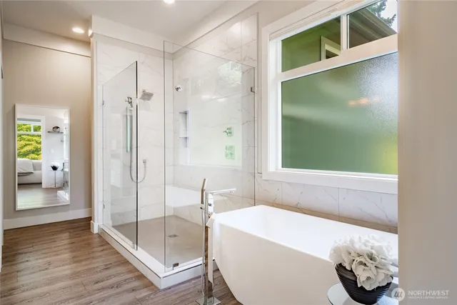a bathroom with a tub and shower
