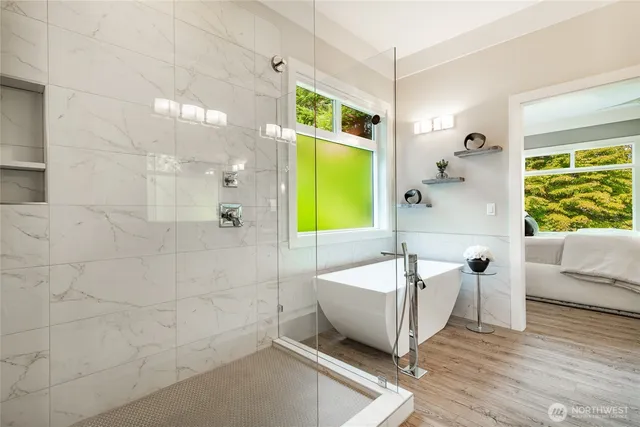 a spacious bathroom with a bathtub and a shower