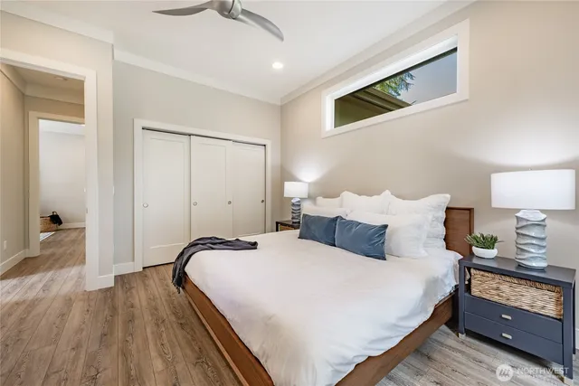 a bedroom with bed and wooden floor