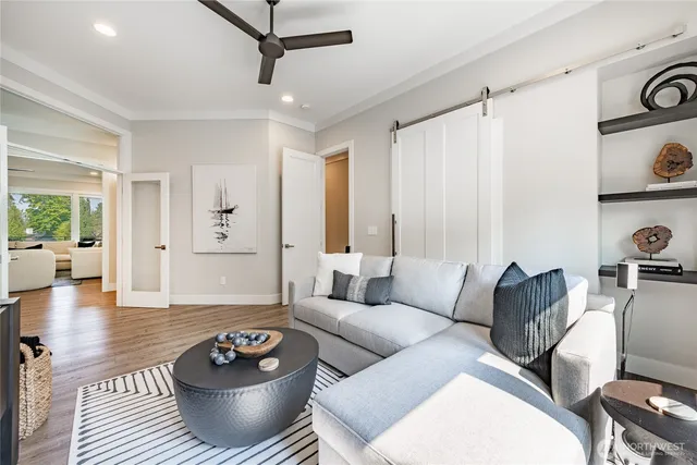 a living room with furniture and a wooden floor