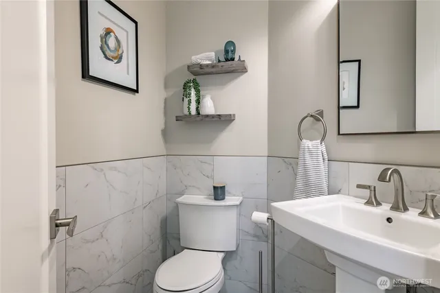 a bathroom with a toilet sink and mirror