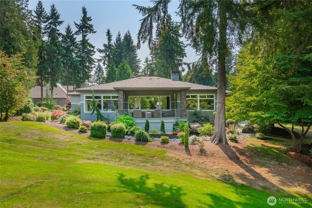 a view of a patio with table and chairs under an umbrella