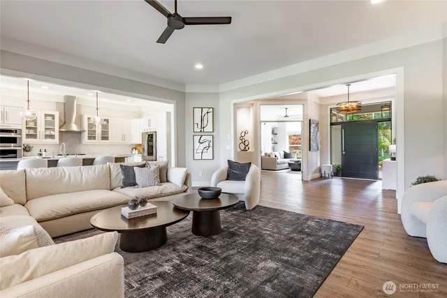 a living room with furniture wooden floor and a table