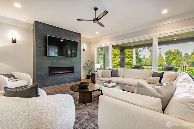 a living room with furniture fireplace and a large window