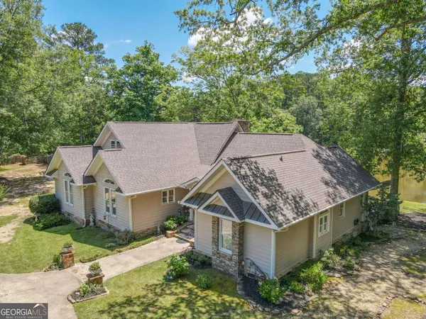 a kitchen with stainless steel appliances granite countertop a stove top oven a sink dishwasher a dining table and chairs with wooden floor