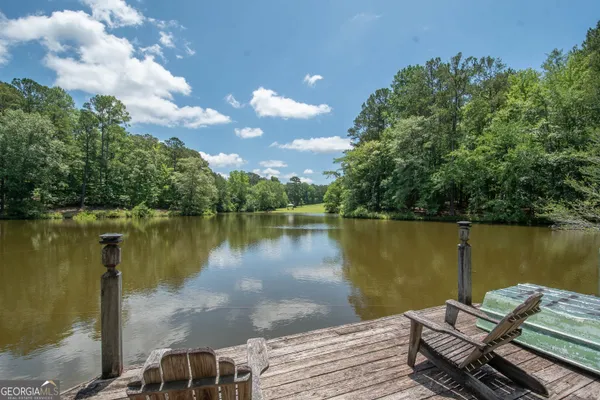a view of a lake in between two large trees