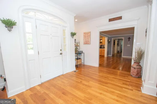 a bedroom with bed and wooden floor