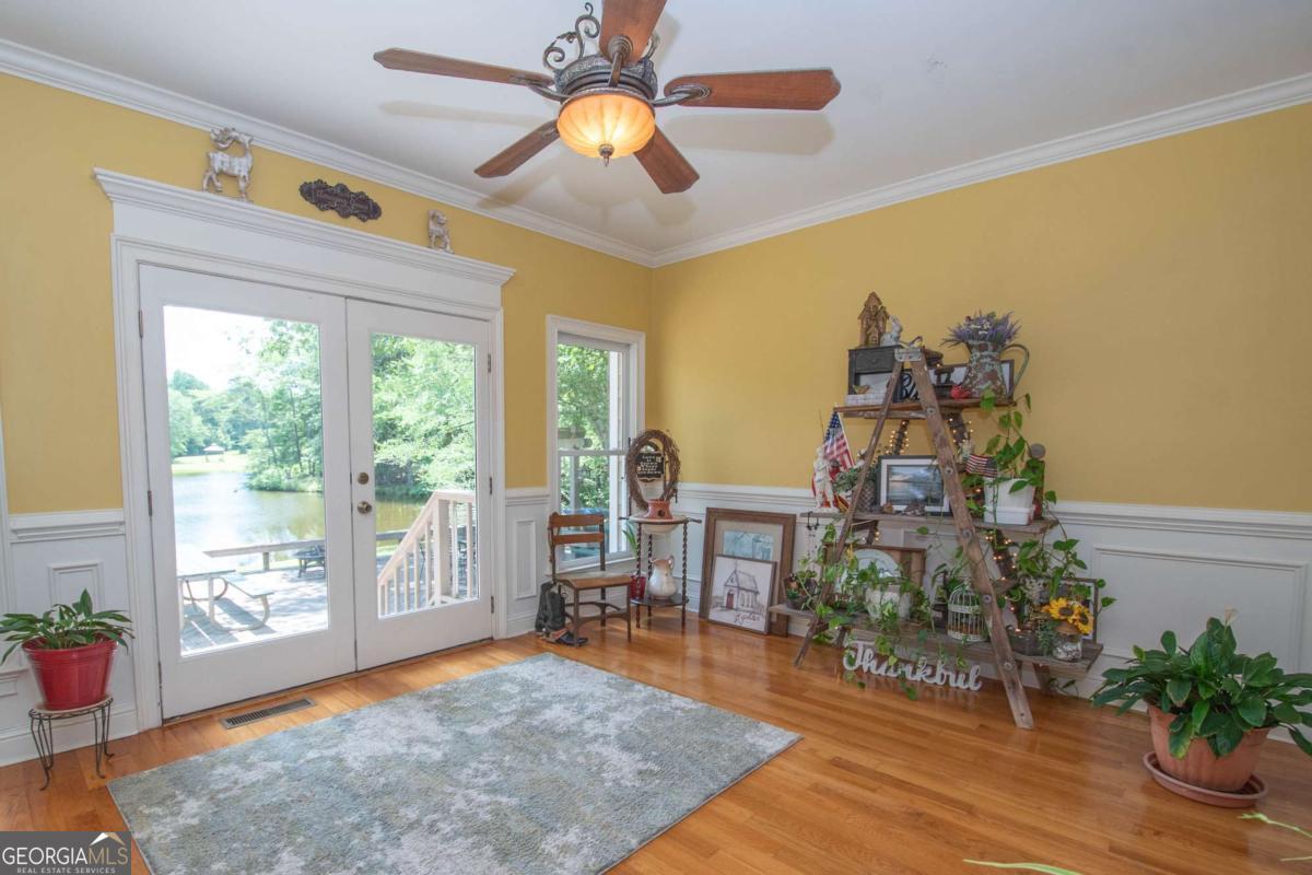 4973 Greenville Road LaGrange, GA 30241 - Photo 32 of 108 a living room with furniture a dining table and a potted plant