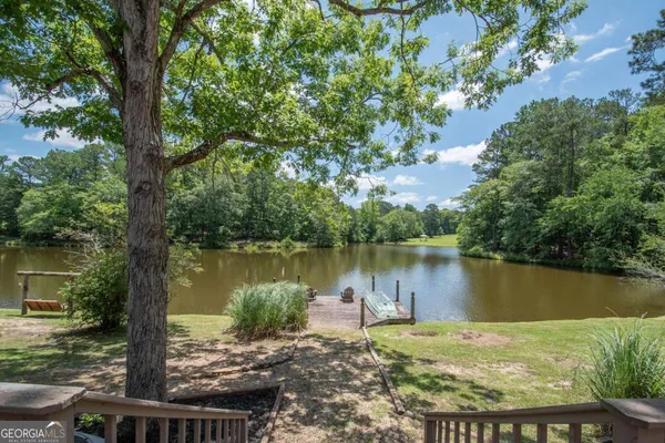an aerial view of a house with a yard and lake view