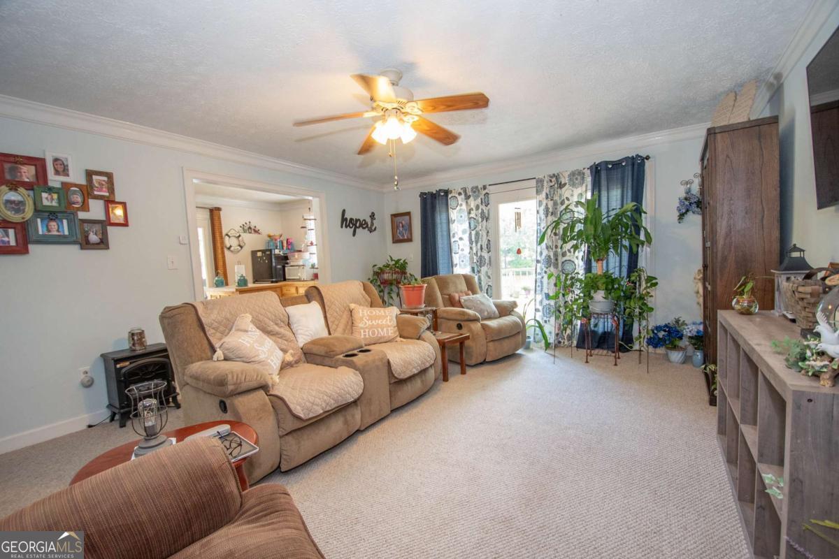 4973 Greenville Road LaGrange, GA 30241 - Photo 52 of 108 a living room with furniture and a flat screen tv