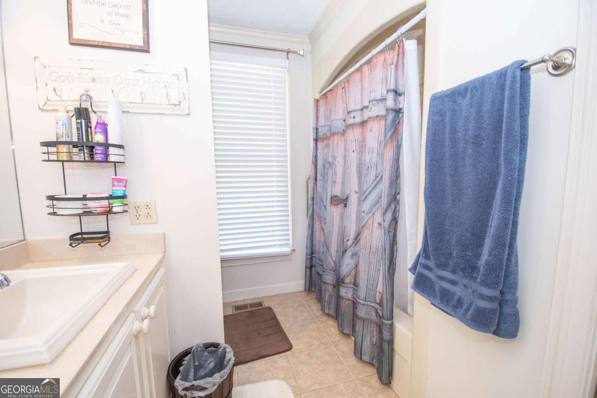 4973 Greenville Road LaGrange, GA 30241 - Photo 56 of 108 a bathroom with a sink a mirror and a shower
