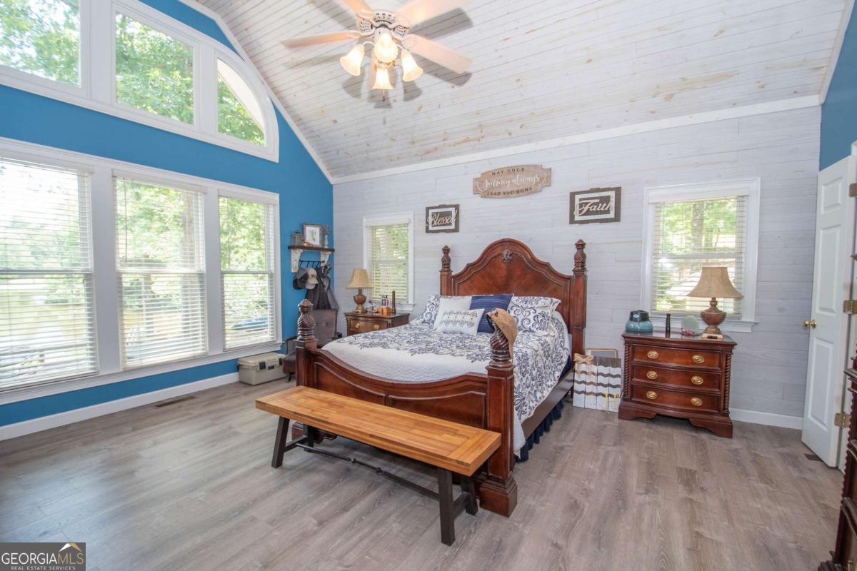 4973 Greenville Road LaGrange, GA 30241 - Photo 62 of 108 a bedroom with a bed and a chandelier
