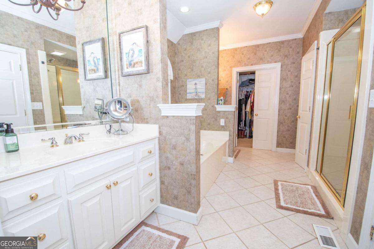 4973 Greenville Road LaGrange, GA 30241 - Photo 64 of 108 a spacious bathroom with a double vanity sink a mirror and a shower