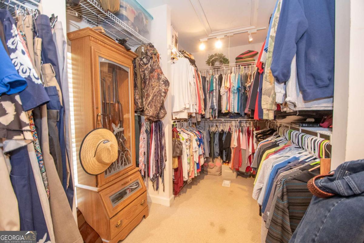 4973 Greenville Road LaGrange, GA 30241 - Photo 68 of 108 a view of walk in closet with clothes