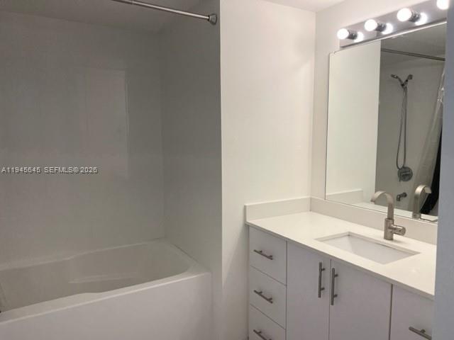 480 Northeast 30th Street, Unit 1803 Miami, FL 33137 - Photo 7 of 15 a bathroom with a bathtub sink vanity and mirror