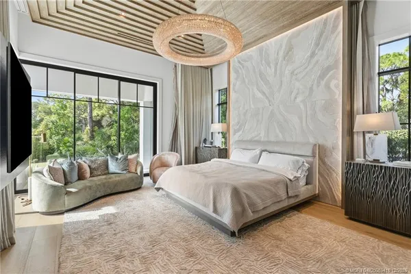 a bedroom with a bed and a television