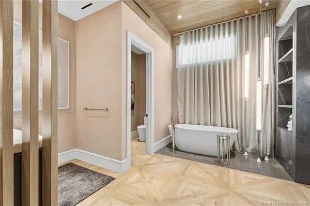 a bathroom with a granite countertop sink and a toilet