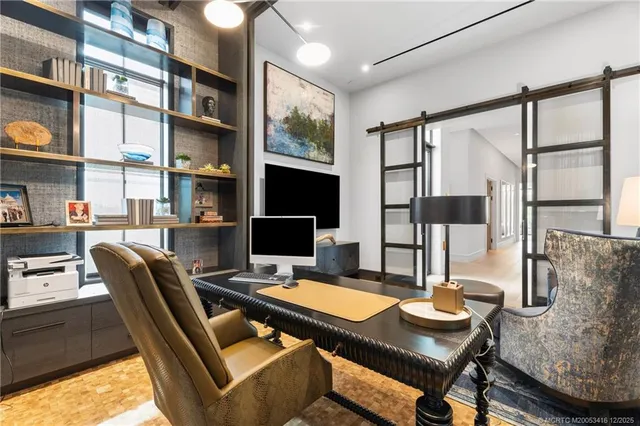 a spacious bedroom with a bed and large windows