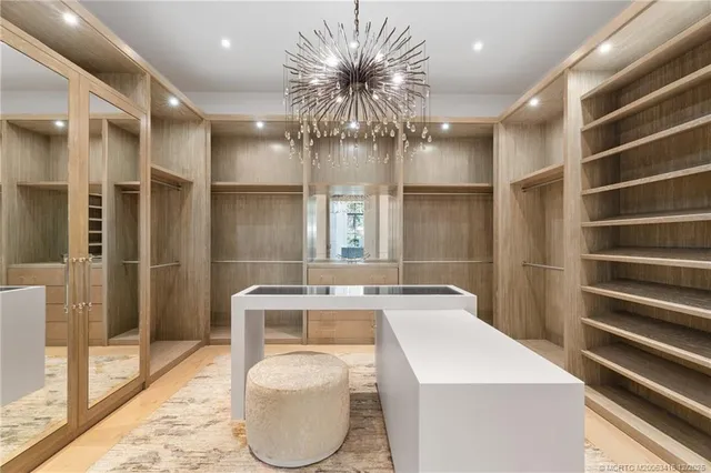 a spacious bedroom with a bed and a flat screen tv