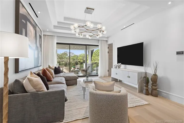 a view of a swimming pool with a patio and a yard