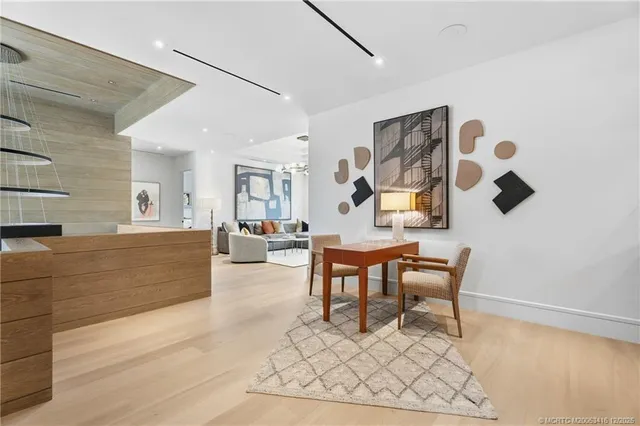 a view of a patio with a table and chairs under an umbrella