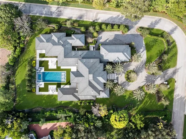 a living room with furniture a large window and wooden floor