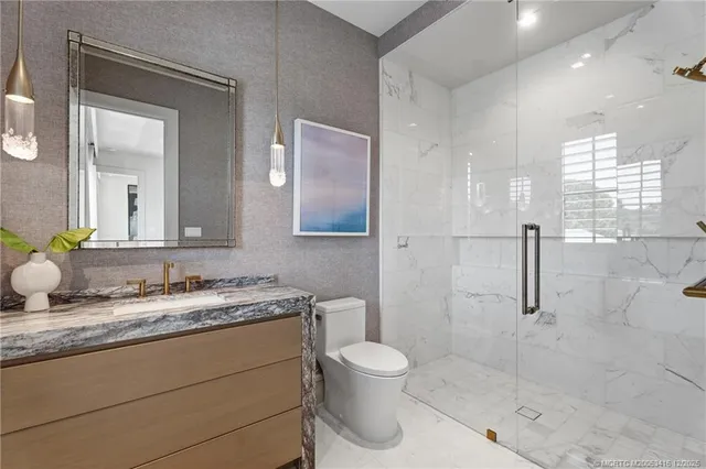 a view of a house with a yard and palm trees