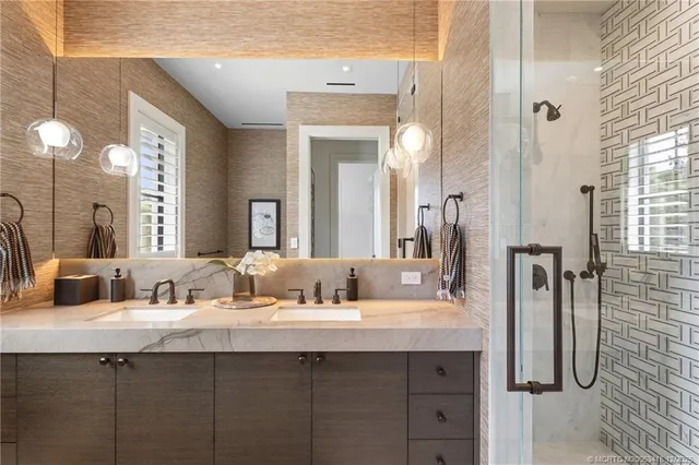 a view of a white house with a yard and palm trees