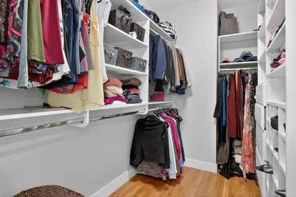 a view of walk in closet with clothes