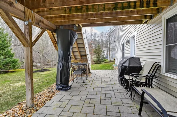 a view of a patio with table and chairs and potted plants