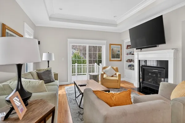 a living room with furniture a fireplace and a flat screen tv