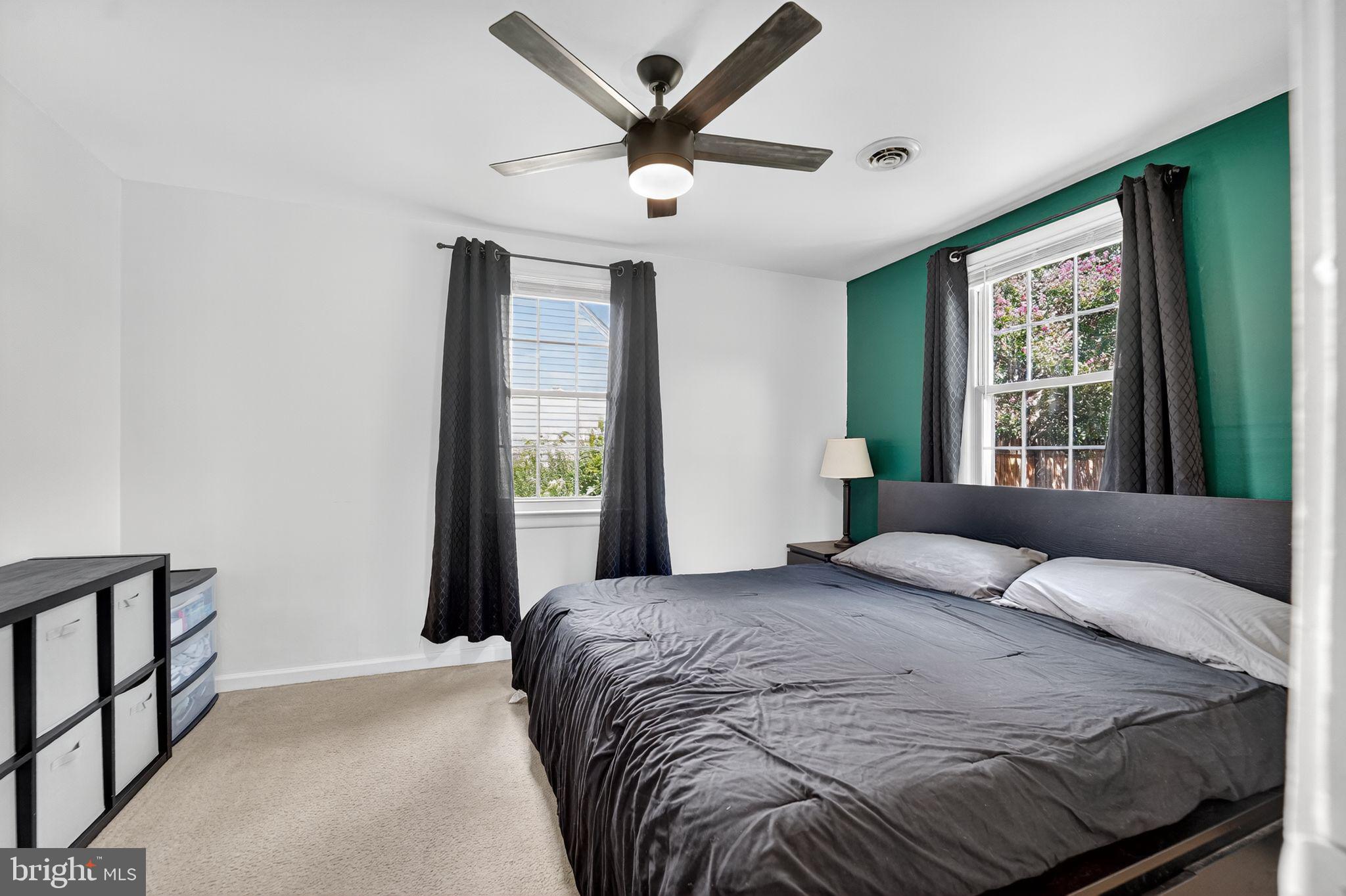 3127 Cornwall Road Baltimore, MD 21222 - Photo 13 of 24 a bedroom with a large bed and a large window