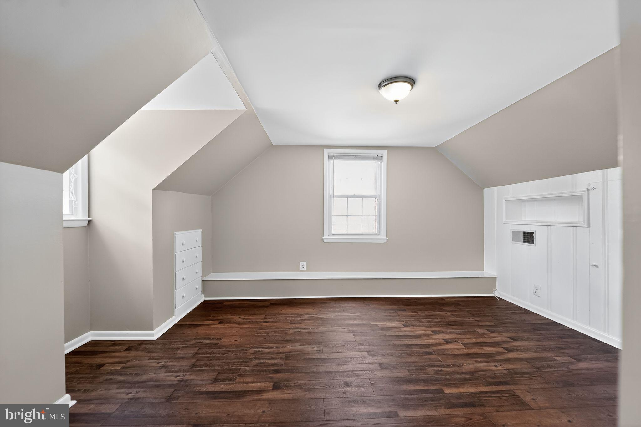 3127 Cornwall Road Baltimore, MD 21222 - Photo 18 of 24 an empty room with wooden floor and windows