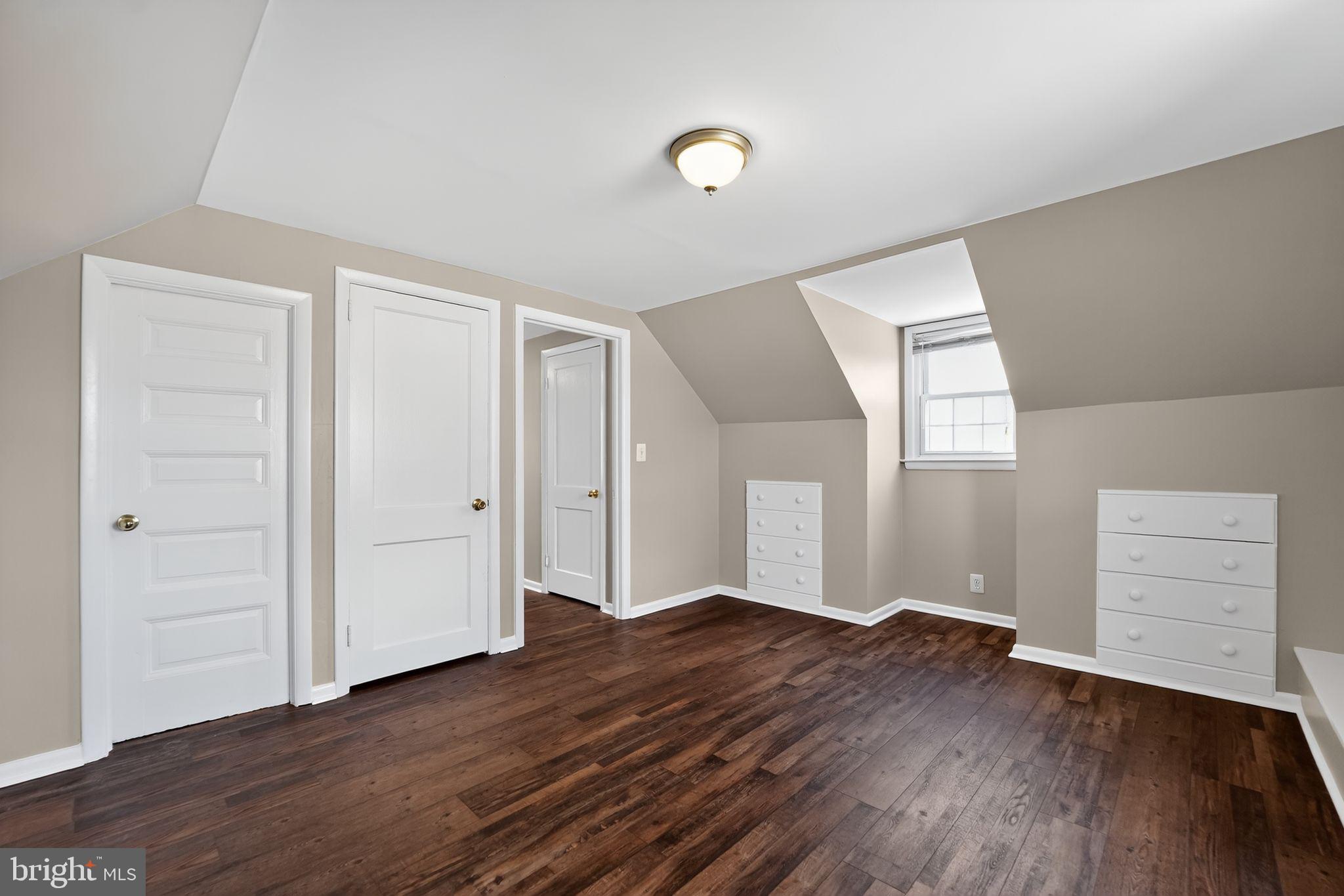 3127 Cornwall Road Baltimore, MD 21222 - Photo 19 of 24 an empty room with wooden floor & cabinet and window