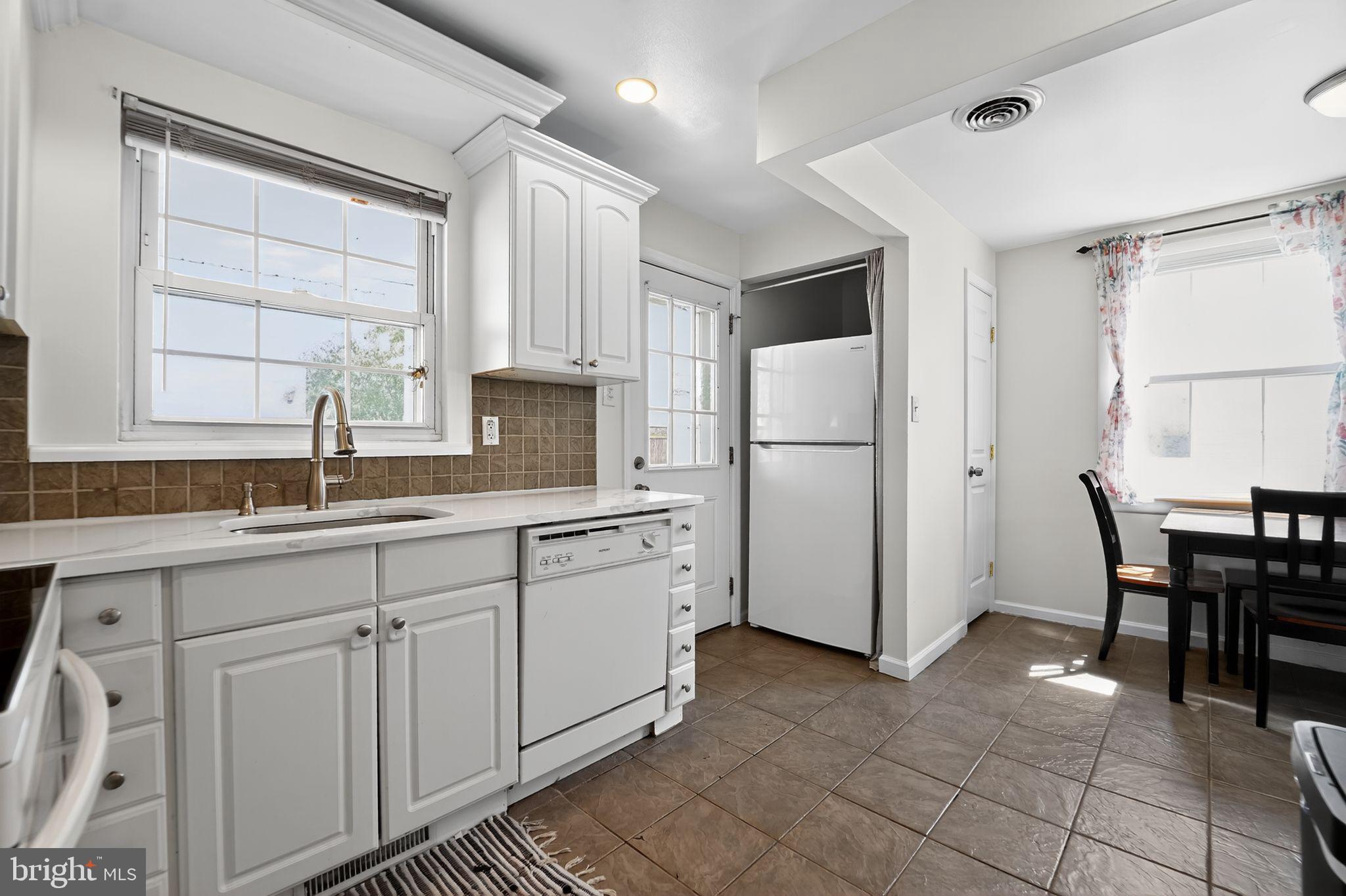 3127 Cornwall Road Baltimore, MD 21222 - Photo 6 of 24 a kitchen with white cabinets and white appliances