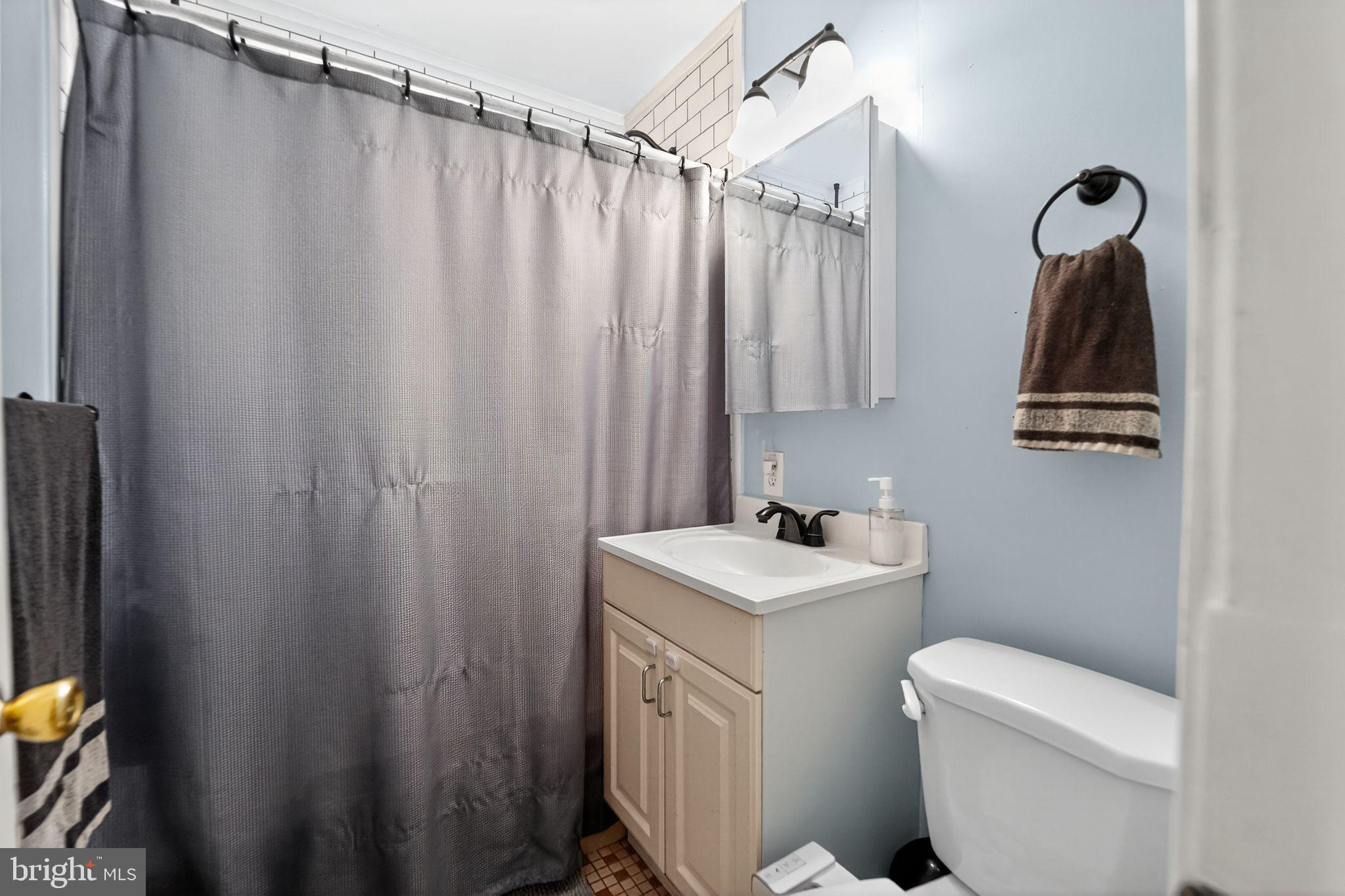 3127 Cornwall Road Baltimore, MD 21222 - Photo 10 of 24 a bathroom with a sink a toilet and shower