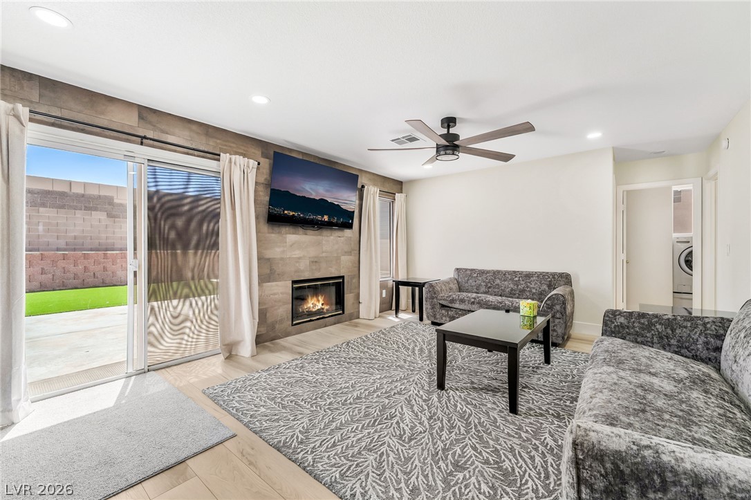104 Appian Way Henderson, NV 89002 - Photo 5 of 24 An inviting open-concept living space features a modern fireplace and direct backyard access.
