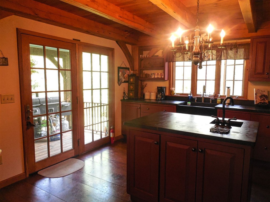 2860 Greenwich Road Hardwick, MA 01082 - Photo 10 of 28 a kitchen with a sink and wooden cabinets