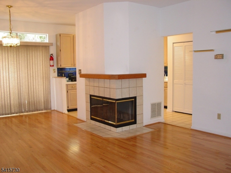 13 Wood Duck Pond Road Bedminster, NJ 07921 - Photo 1 of 13 a view of empty room with wooden floor and fireplace