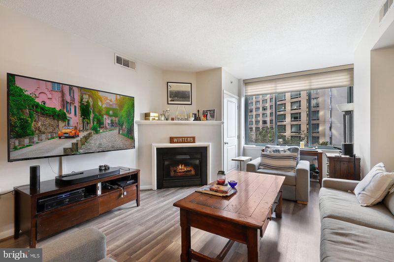 a living room with furniture a flat screen tv and a fireplace