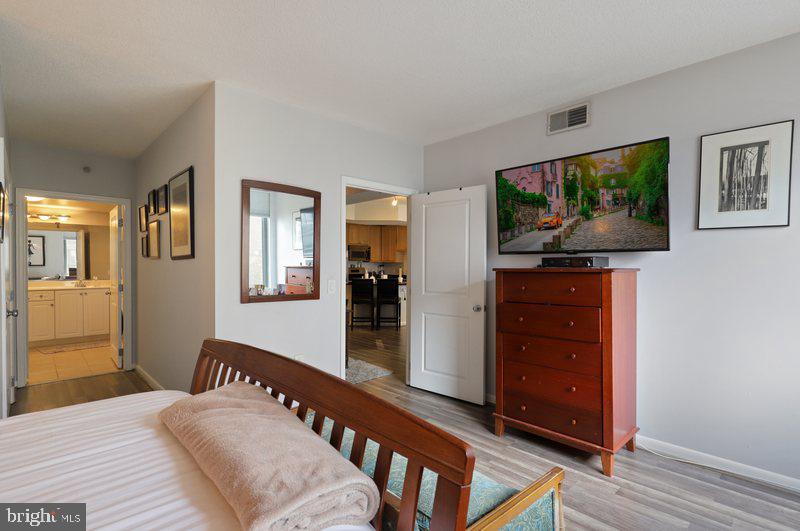 851 North Glebe Road, Unit 520 Arlington, VA 22203 - Photo 12 of 28 a bedroom with furniture and a flat screen tv