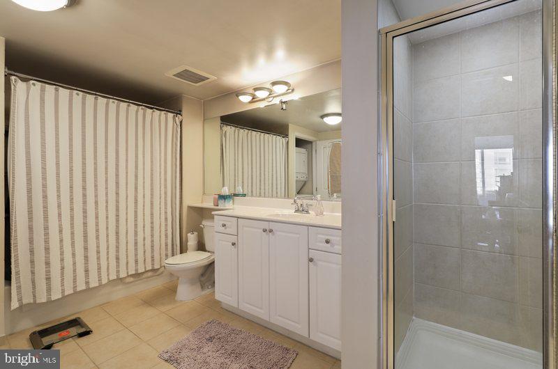 851 North Glebe Road, Unit 520 Arlington, VA 22203 - Photo 13 of 28 a bathroom with a double vanity sink and a mirror