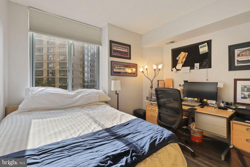 851 North Glebe Road, Unit 520 Arlington, VA 22203 - Photo 19 of 28 a bedroom with a bed and wooden floor