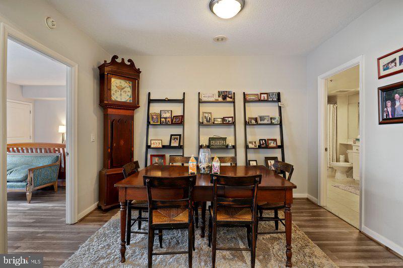 851 North Glebe Road, Unit 520 Arlington, VA 22203 - Photo 3 of 28 a view of a dining room with furniture and a wooden floor