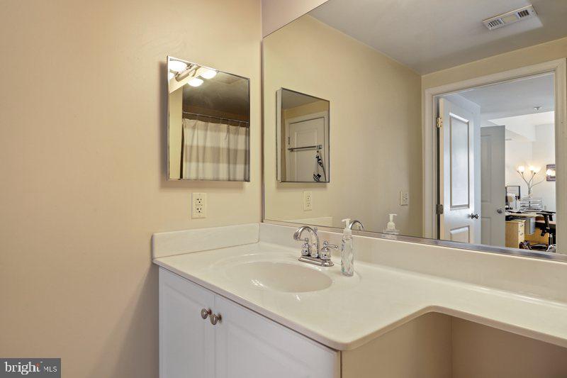 851 North Glebe Road, Unit 520 Arlington, VA 22203 - Photo 21 of 28 a bathroom with a sink and a mirror