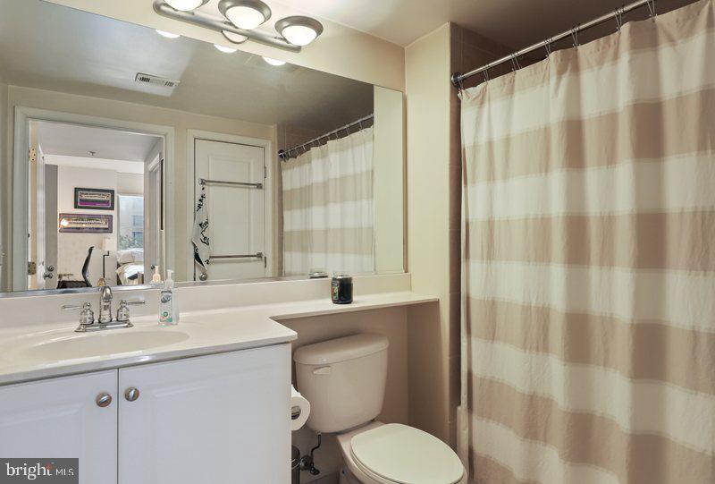 851 North Glebe Road, Unit 520 Arlington, VA 22203 - Photo 22 of 28 a bathroom with a sink a toilet and shower